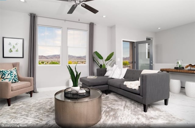 living room featuring recessed lighting, ceiling fan, and baseboards