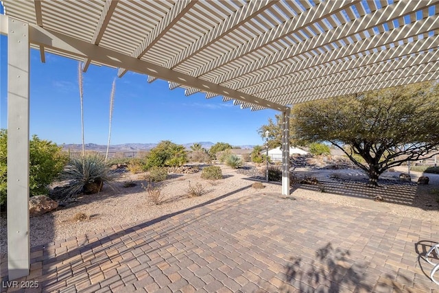 view of patio / terrace with a mountain view and a pergola