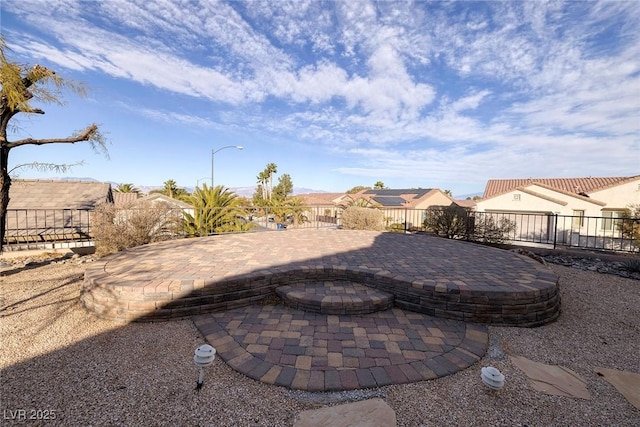 view of yard featuring a residential view, a patio area, and fence