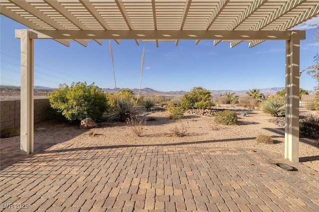 view of patio / terrace with a mountain view and a pergola