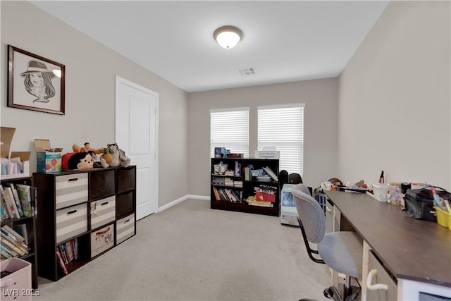 office space featuring light carpet, visible vents, and baseboards