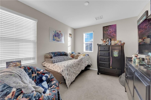 bedroom with light carpet and visible vents