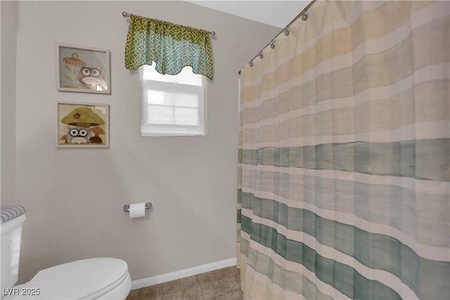 bathroom with a shower with shower curtain, baseboards, toilet, and tile patterned floors