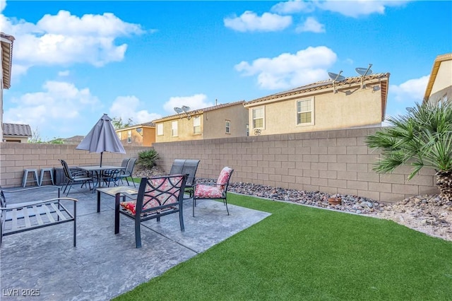 view of yard with outdoor dining area, a fenced backyard, and a patio