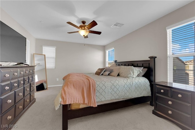 bedroom featuring baseboards, a ceiling fan, visible vents, and light colored carpet