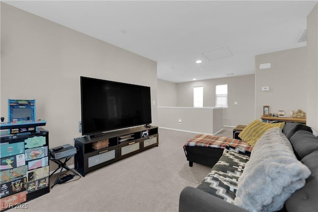 living room featuring attic access, carpet, baseboards, and recessed lighting