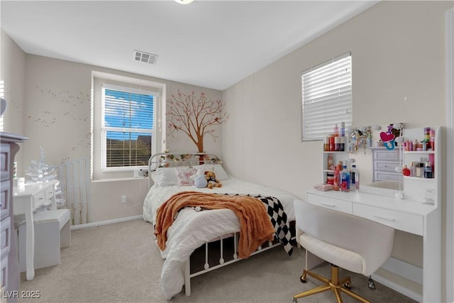 bedroom with baseboards, visible vents, and light colored carpet