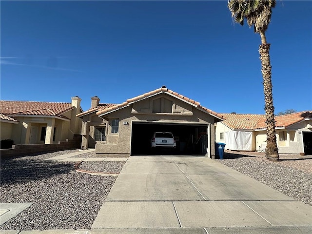 view of front of property with a chimney, stucco siding, concrete driveway, a garage, and a tiled roof