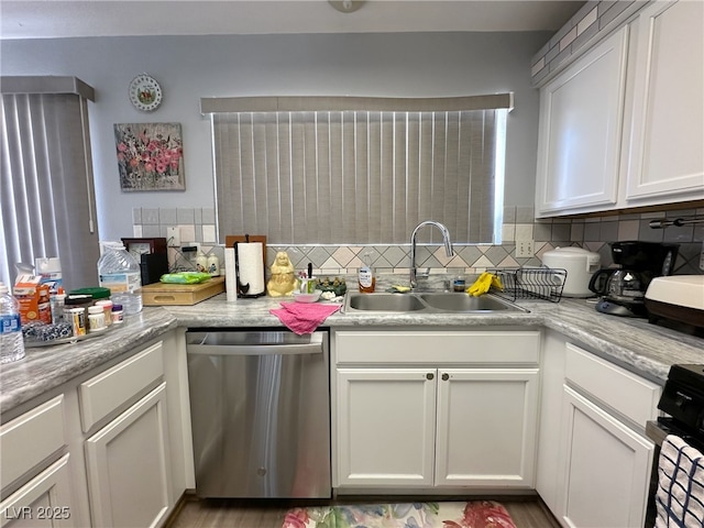 kitchen featuring a sink, light countertops, stainless steel dishwasher, range, and decorative backsplash