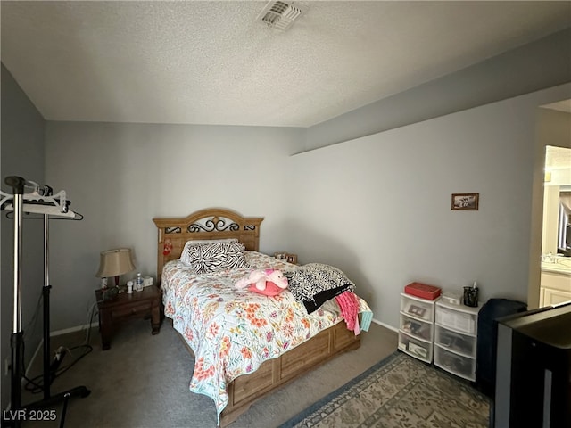 bedroom with baseboards, carpet, visible vents, and a textured ceiling