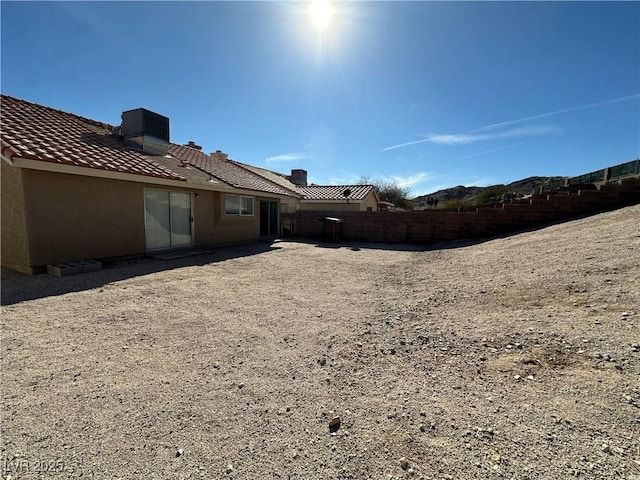 view of yard with central AC unit and fence