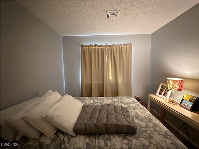 bedroom with visible vents and a textured ceiling