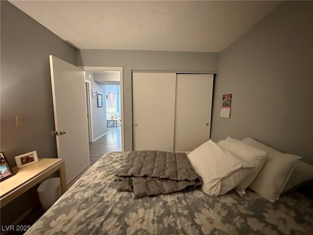 bedroom with a textured ceiling and a closet