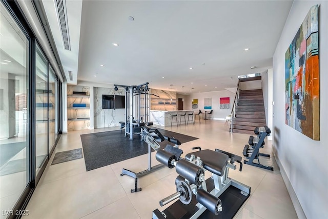 exercise room featuring baseboards and recessed lighting