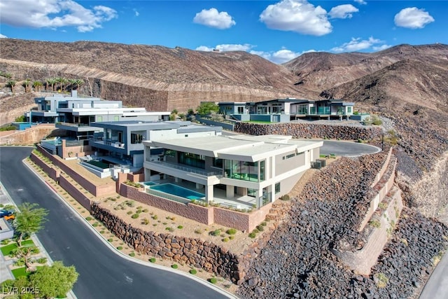 birds eye view of property featuring a mountain view