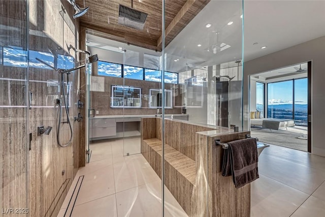 full bathroom with an enclosed shower and tile patterned floors