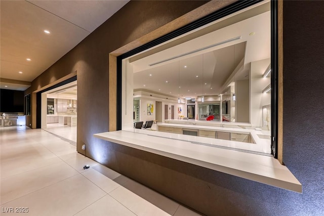 hall featuring tile patterned floors and recessed lighting