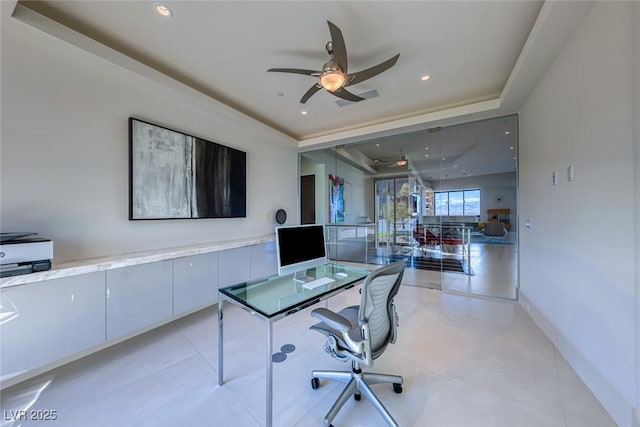 office space featuring baseboards, a tray ceiling, a ceiling fan, and recessed lighting