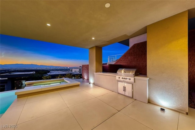 patio terrace at dusk with area for grilling