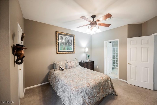 bedroom with baseboards, carpet floors, ensuite bathroom, and a ceiling fan