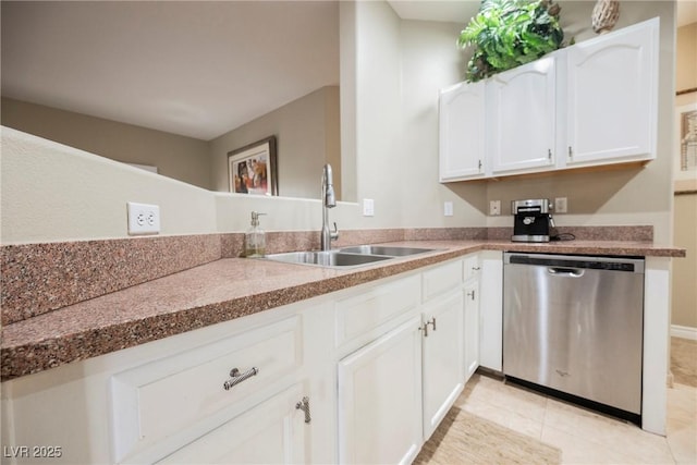 kitchen with light tile patterned floors, dishwasher, white cabinetry, and a sink