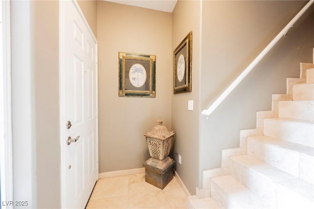 stairway with tile patterned flooring and baseboards