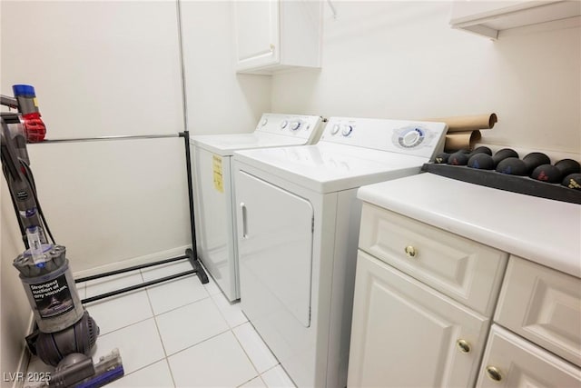 laundry room with cabinet space, separate washer and dryer, and light tile patterned flooring