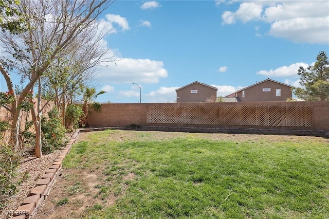 view of yard with a fenced backyard