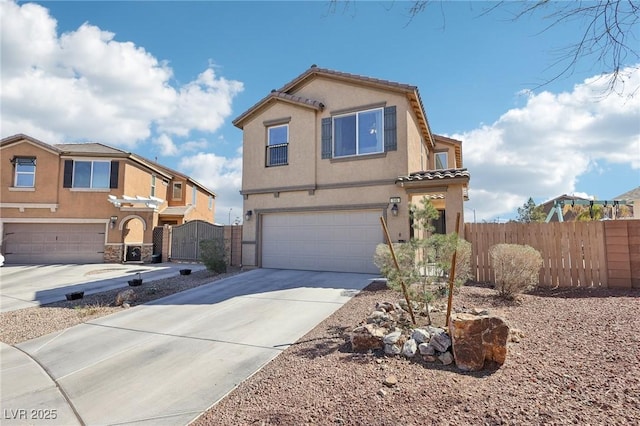 view of front of house featuring an attached garage, driveway, fence, and stucco siding