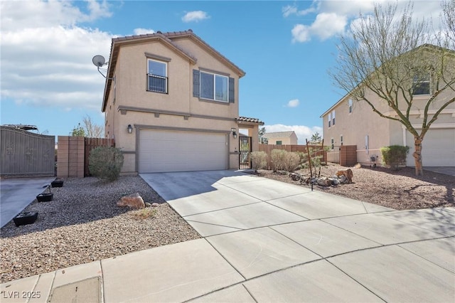 traditional home with driveway, a garage, a gate, fence, and stucco siding