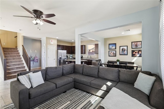 living area with light tile patterned floors, ceiling fan, recessed lighting, visible vents, and stairway