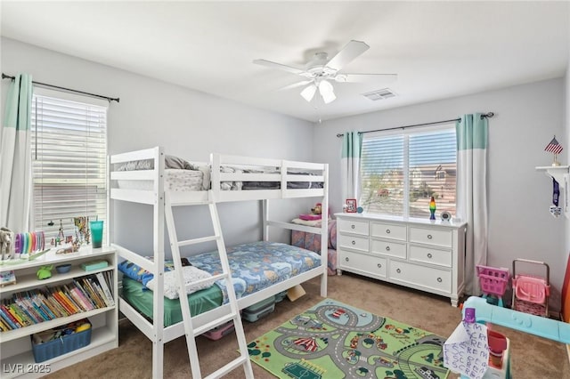 carpeted bedroom featuring visible vents and ceiling fan