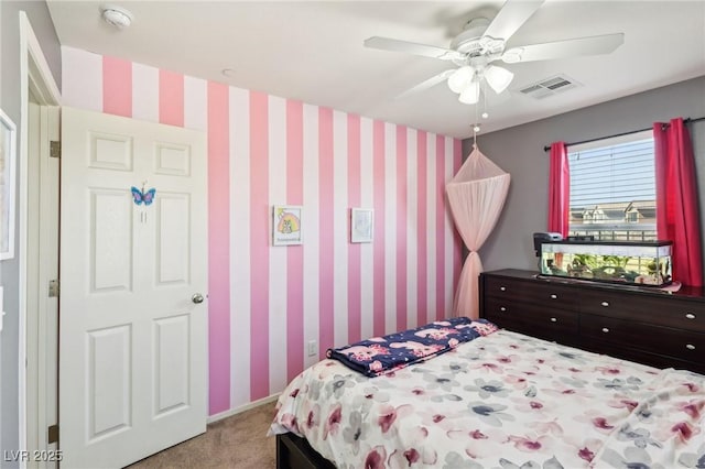 bedroom with light carpet, wallpapered walls, ceiling fan, and visible vents