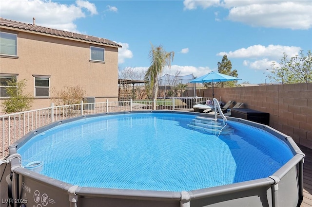 view of pool featuring a fenced in pool and a fenced backyard