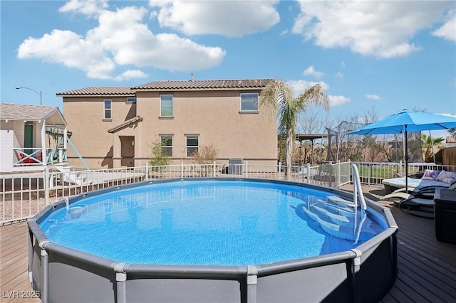 view of pool with a fenced in pool and fence