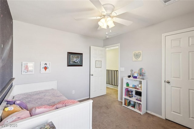 carpeted bedroom featuring visible vents, baseboards, and a ceiling fan