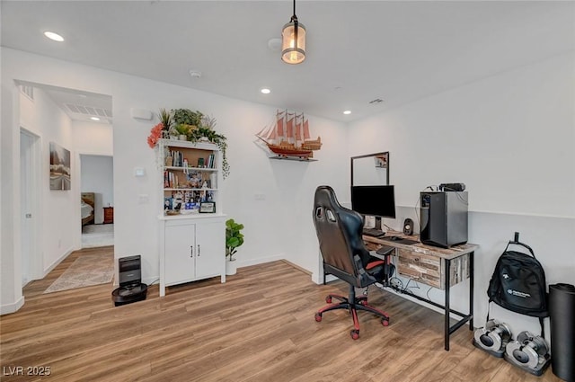 home office with light wood-type flooring and recessed lighting