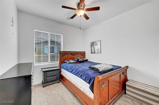 bedroom featuring ceiling fan, baseboards, visible vents, and light colored carpet