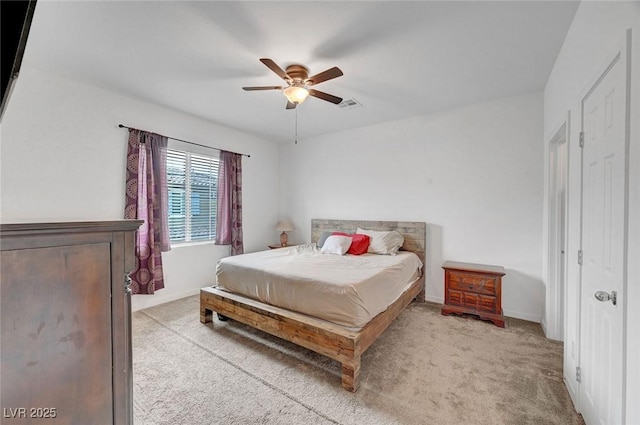 bedroom with a ceiling fan, visible vents, light carpet, and baseboards