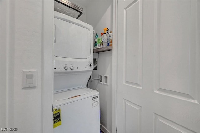 laundry area with stacked washing maching and dryer