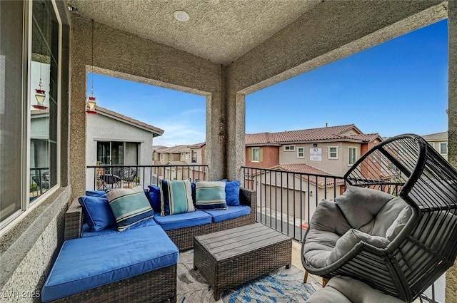 balcony with a residential view and an outdoor hangout area