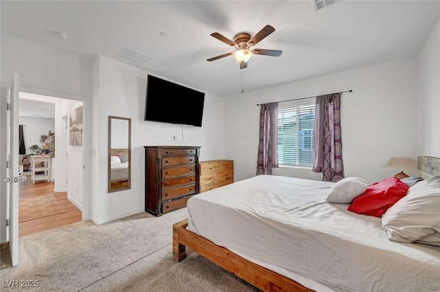 bedroom featuring baseboards, carpet floors, visible vents, and a ceiling fan