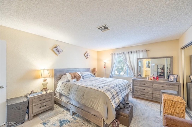 bedroom featuring visible vents and a textured ceiling