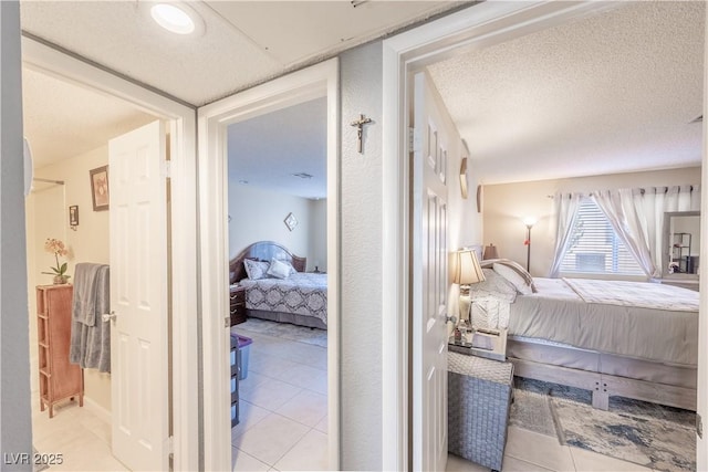 bedroom featuring a textured ceiling and tile patterned floors