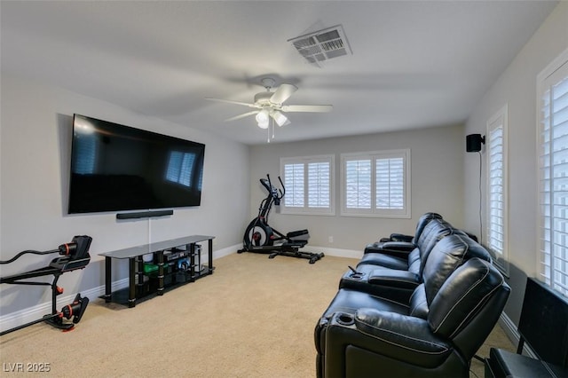 exercise area featuring a ceiling fan, baseboards, visible vents, and carpet flooring