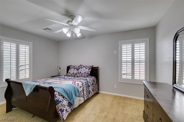 bedroom with baseboards, ceiling fan, visible vents, and light colored carpet