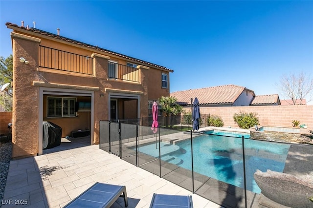 view of swimming pool featuring a fenced in pool, a patio area, a fenced backyard, and a grill