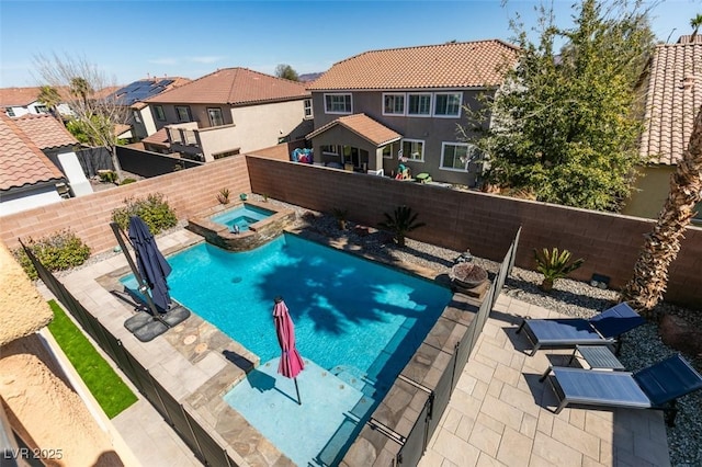 view of pool featuring a residential view, a patio area, a fenced backyard, and a pool with connected hot tub