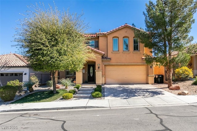 mediterranean / spanish house featuring concrete driveway, a tiled roof, an attached garage, and stucco siding