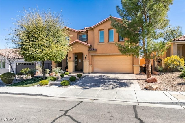 mediterranean / spanish-style home featuring driveway, stucco siding, an attached garage, and a tiled roof